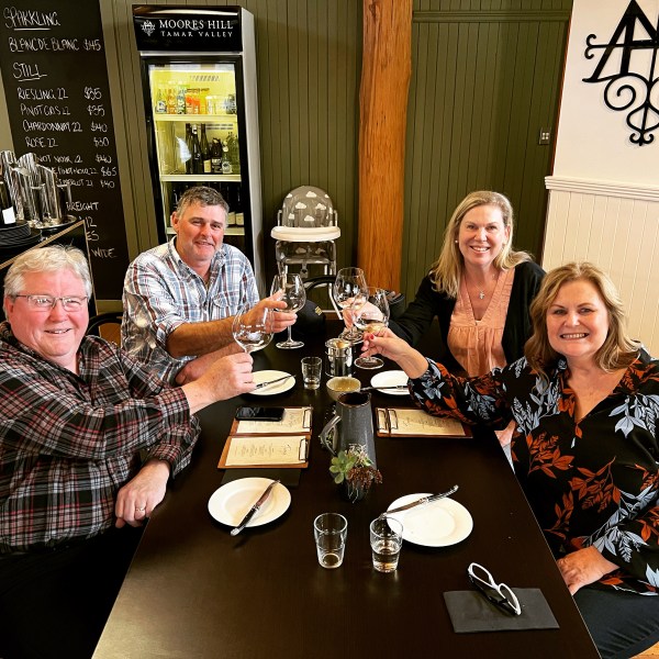 a group of people sitting at a table with wine glasses