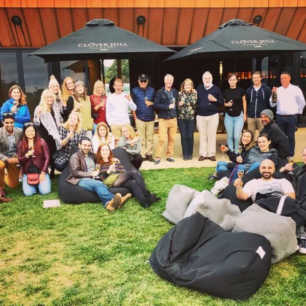 a group of people sitting in the grass