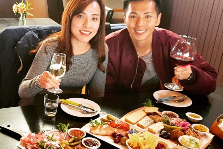 a group of people sitting at a table with a plate of food