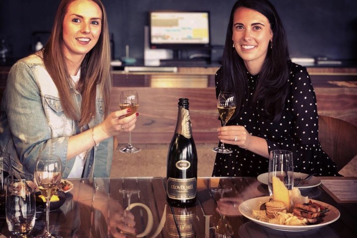 a group of people sitting at a table with wine glasses