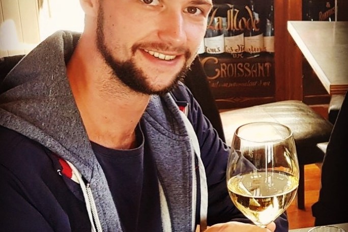 a man sitting at a table with a plate of food