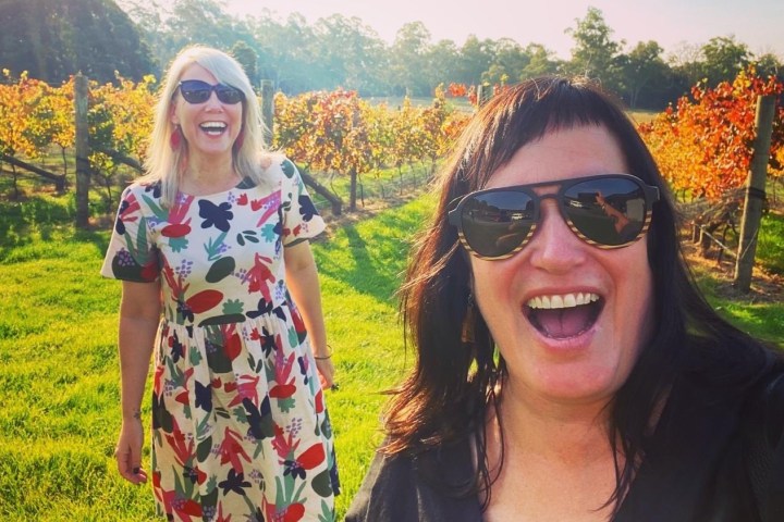 a woman wearing sunglasses posing for the camera