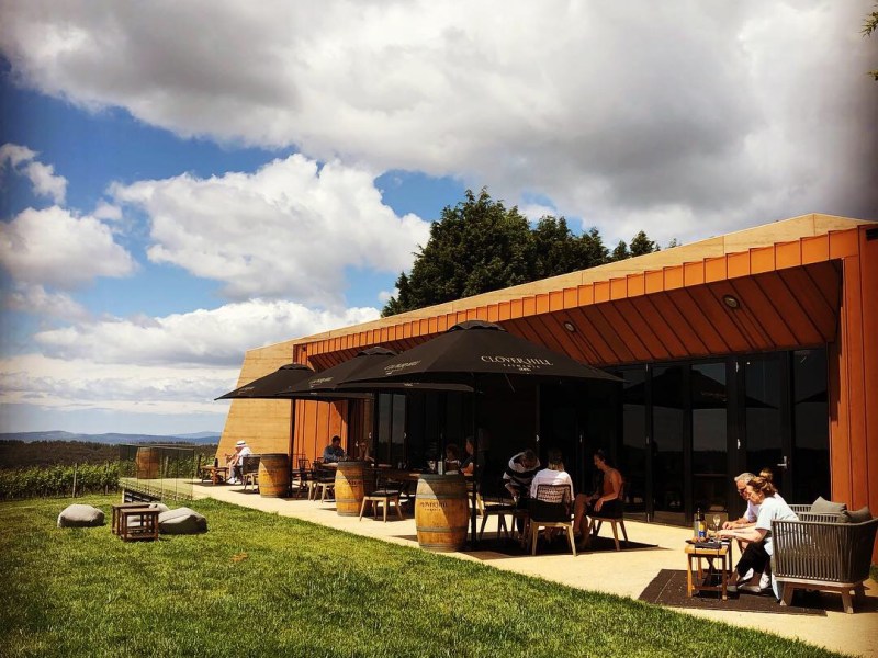 a group of clouds in front of a building