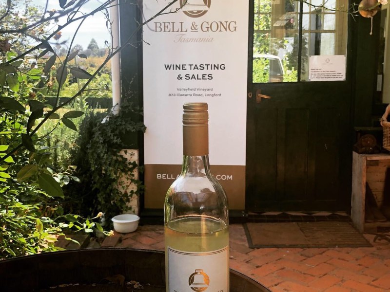 a bottle of wine and a glass of beer on a table